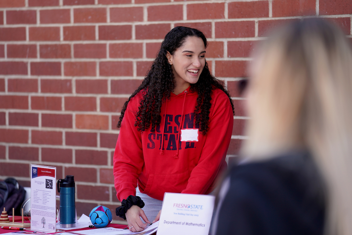 student smiling at booth