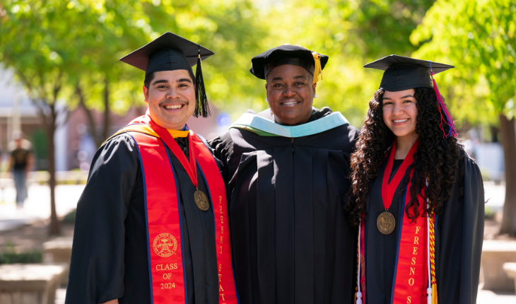 Dean and Students in graduation regalia