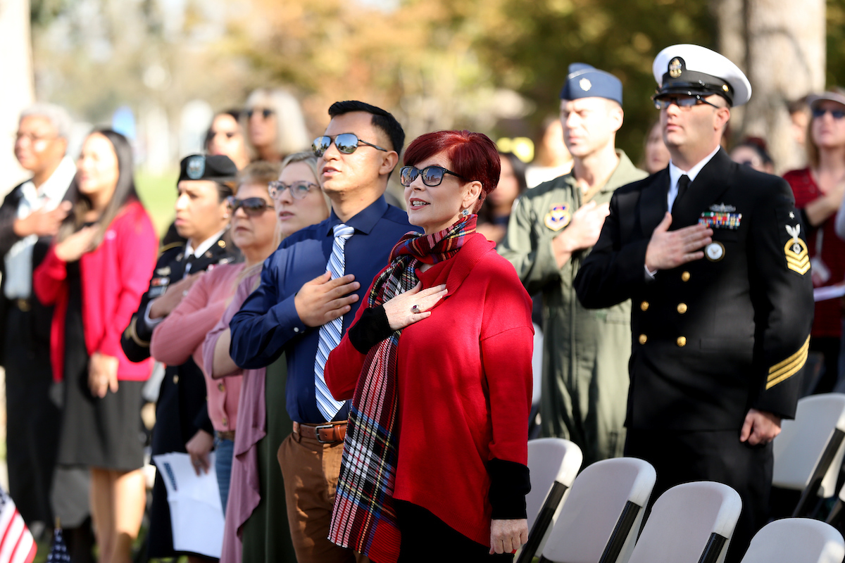 Individuals saluting the flag