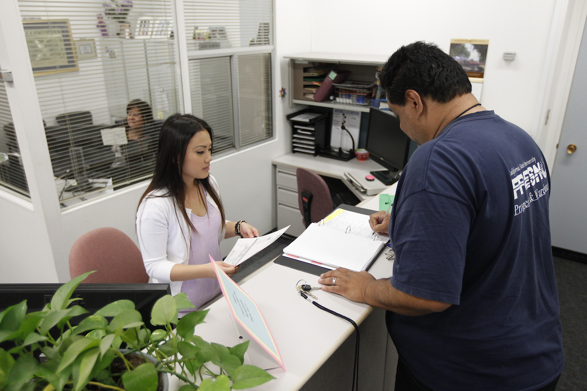 Student meeting with office staff