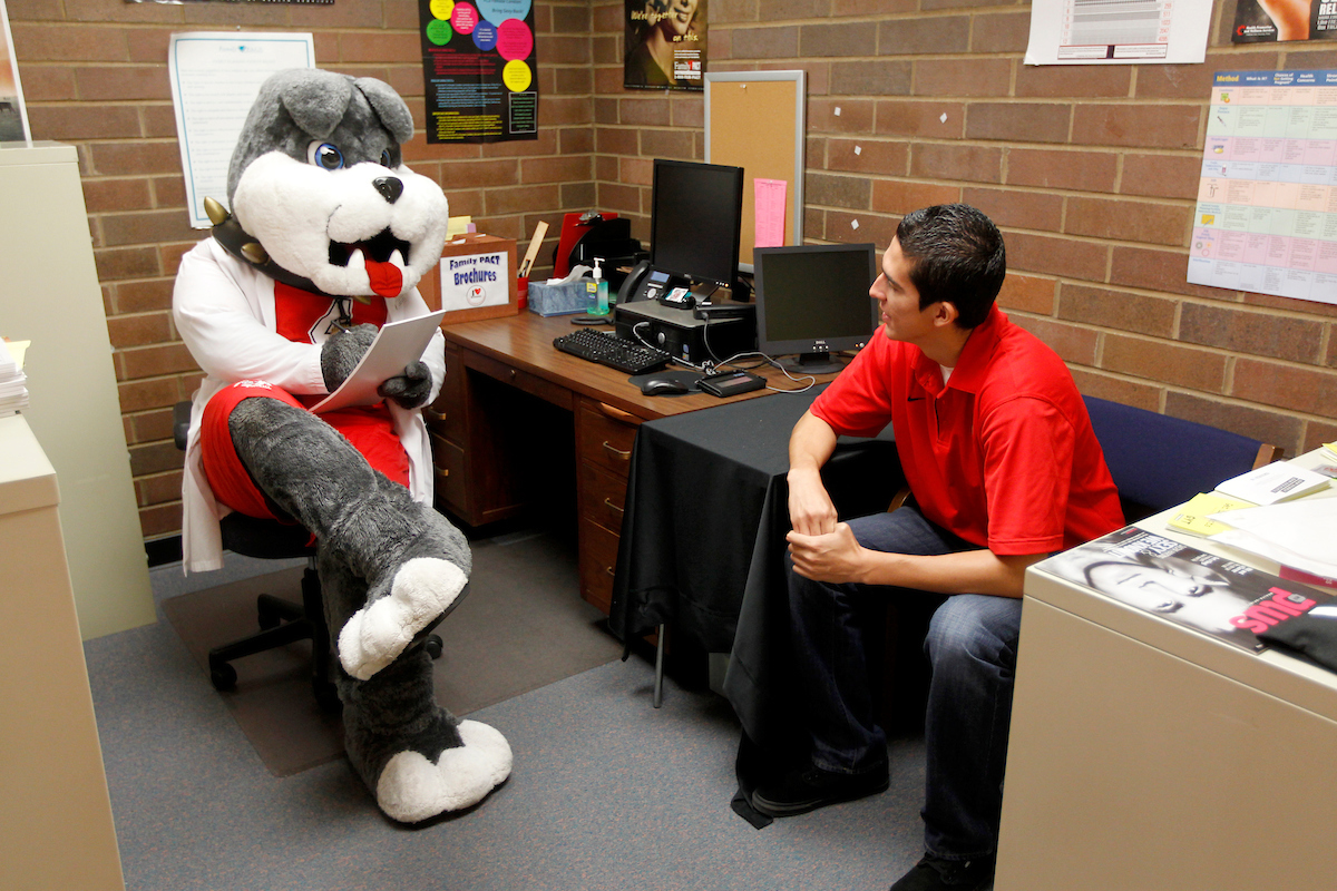 Student meeting with the school mascot