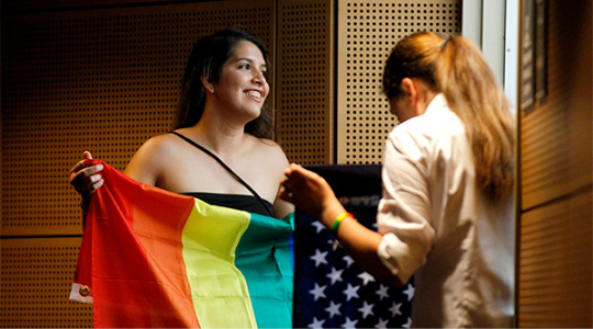 student holding pride flag