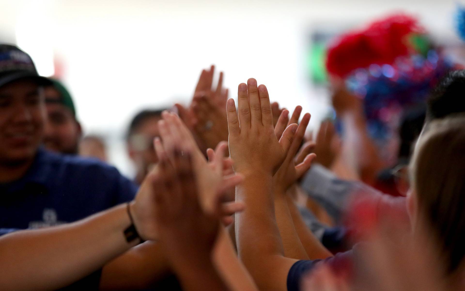 students and staff high-fiving each other