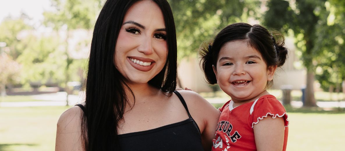 photo of a parent and a child smiling for a photo