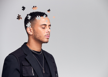A Person with Puzzle Pieces around his Head