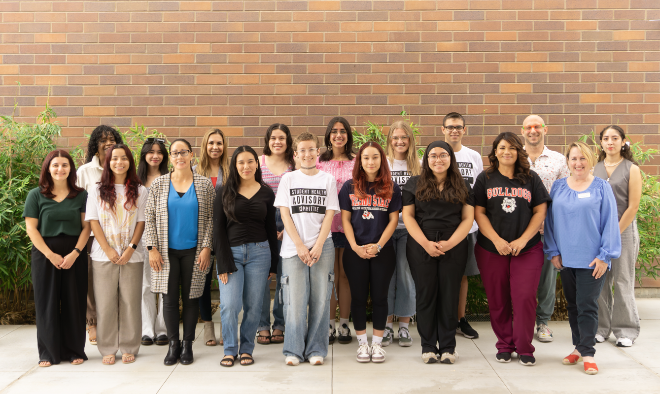 group photo of the student health advisory committe posing and smiling