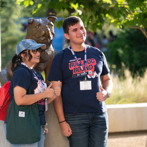 students in front of the bronze bulldog statue