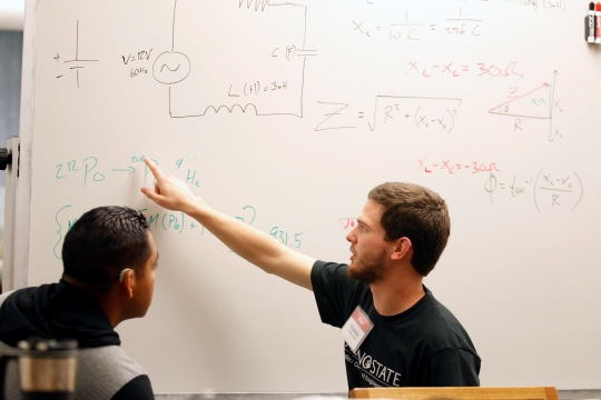 Two students working on the whiteboard