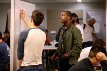 Students learning on white board