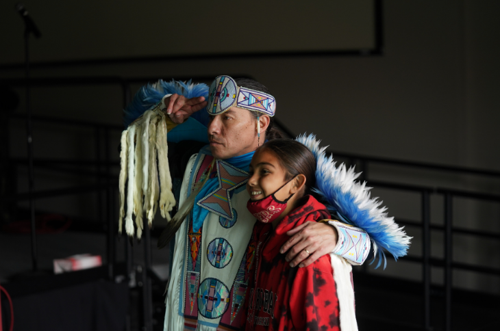 young boy taking a picture with supaman