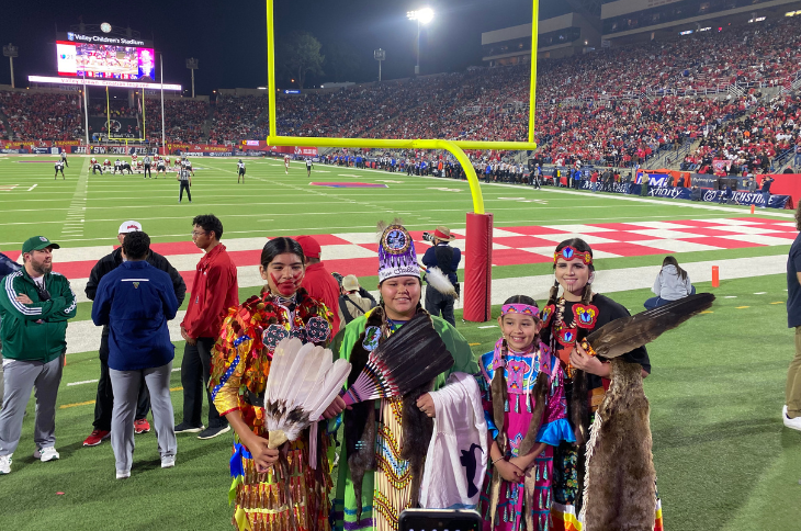girl dancers posing on the football field