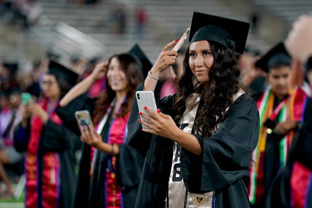 Student Taking Selfie at Graduation in Robes