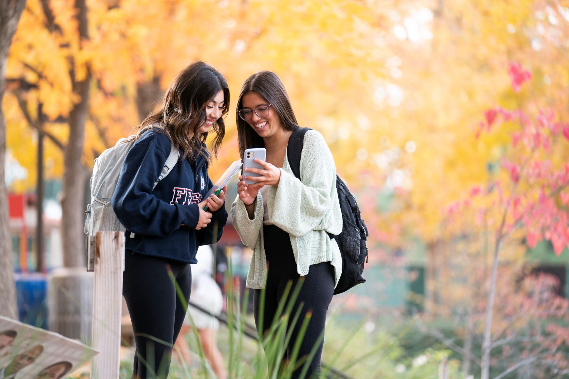 Girls talking holding cell phones