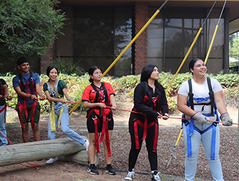 Students participating in a ropes course