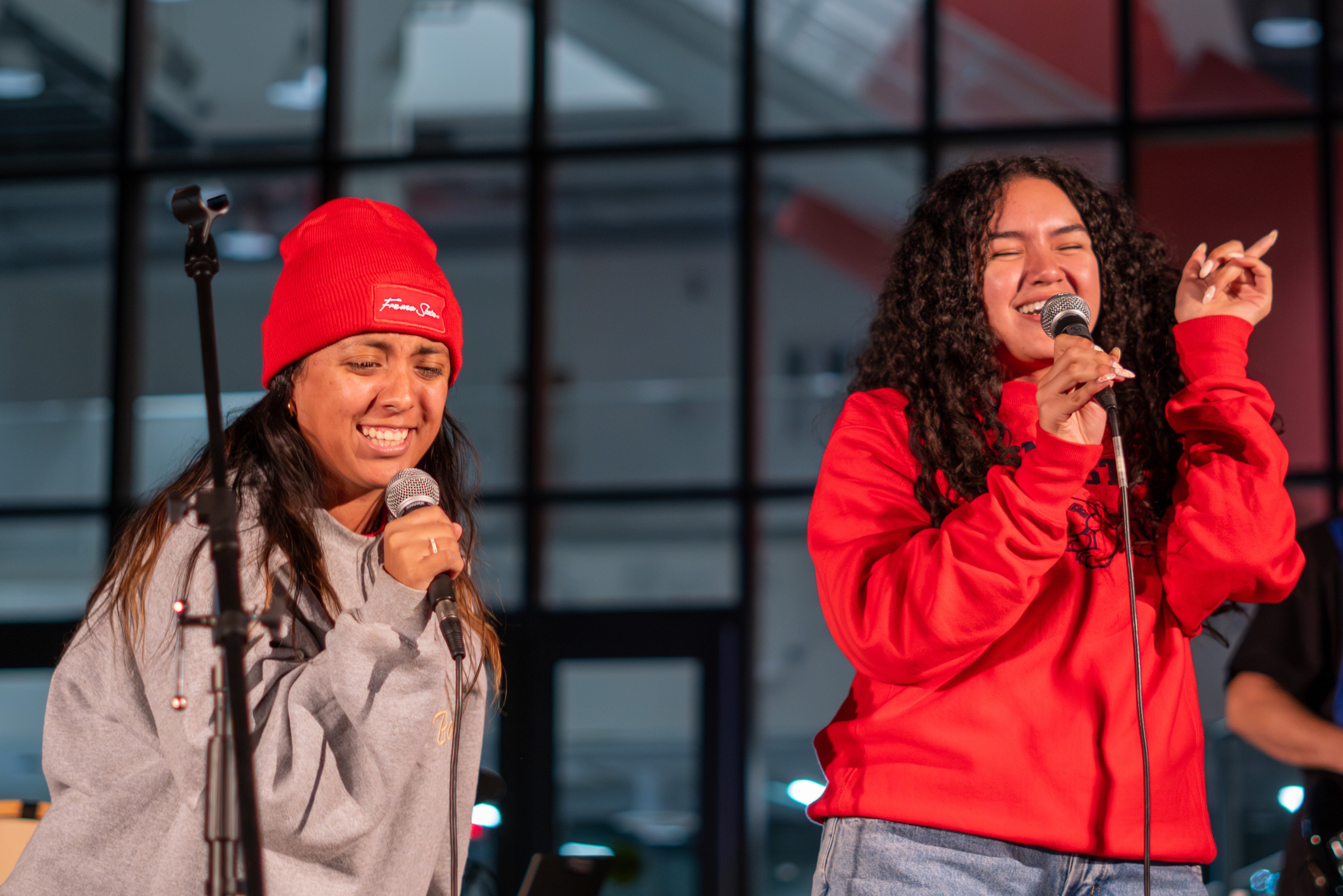 Two students singing at a karaoke event