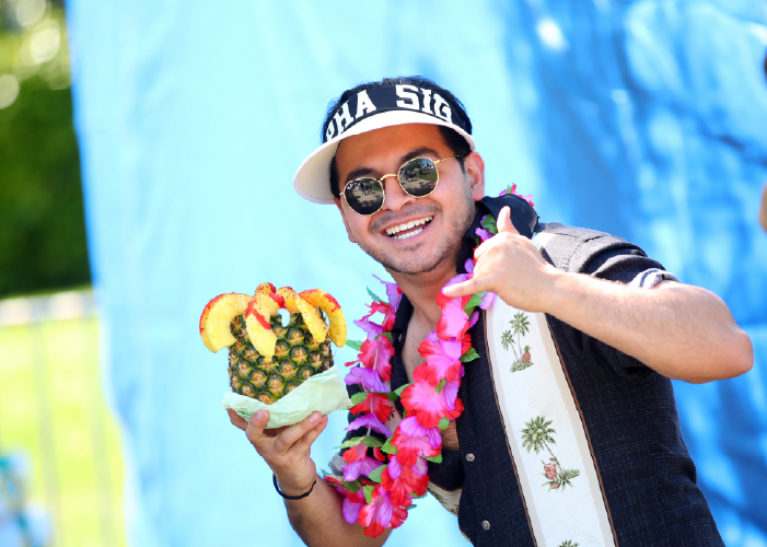 Smiling Student Enjoying a Pineapple Drink During Vintage Days.