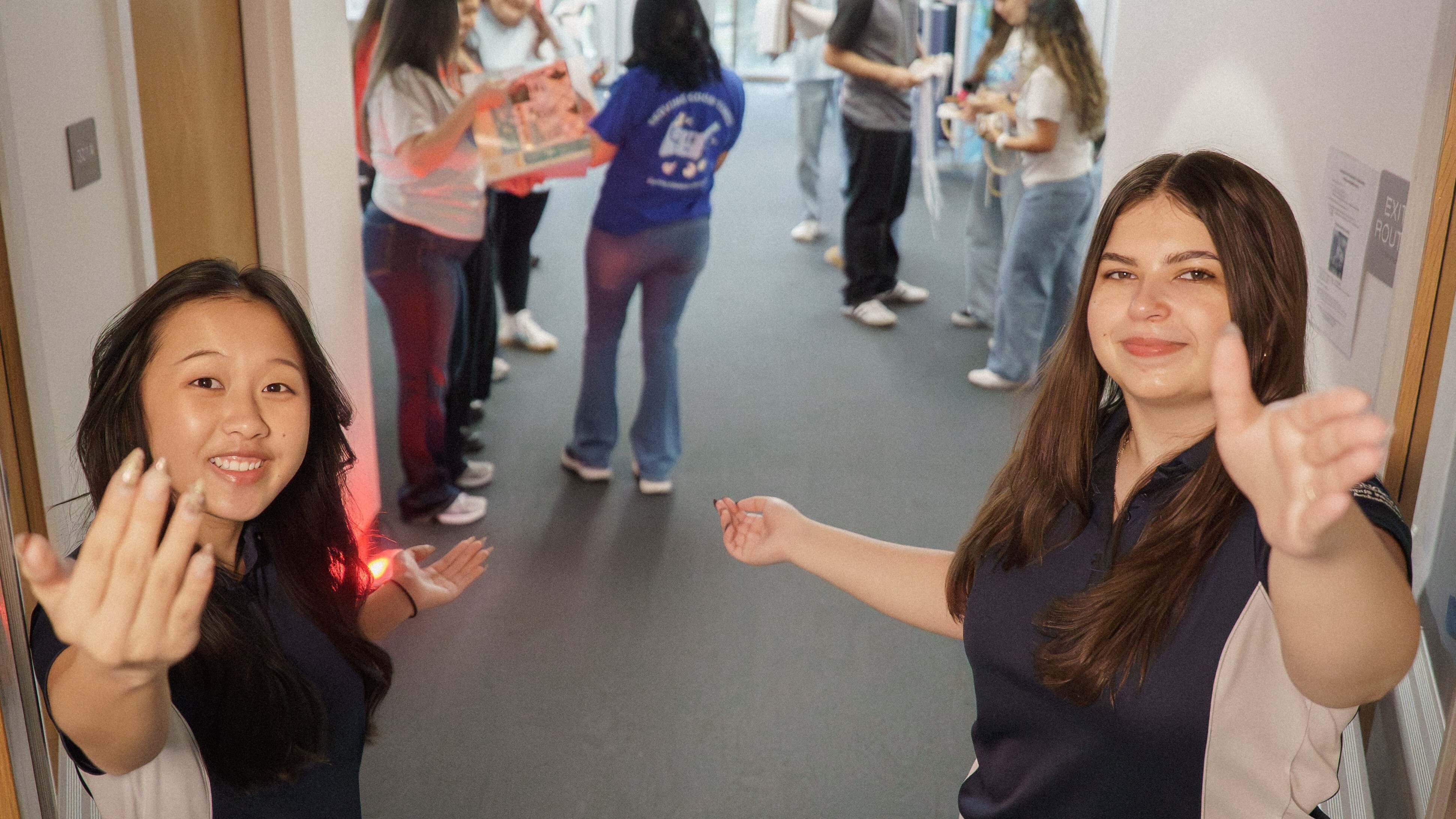 Two students welcoming the viewer into the Student Leader Hub