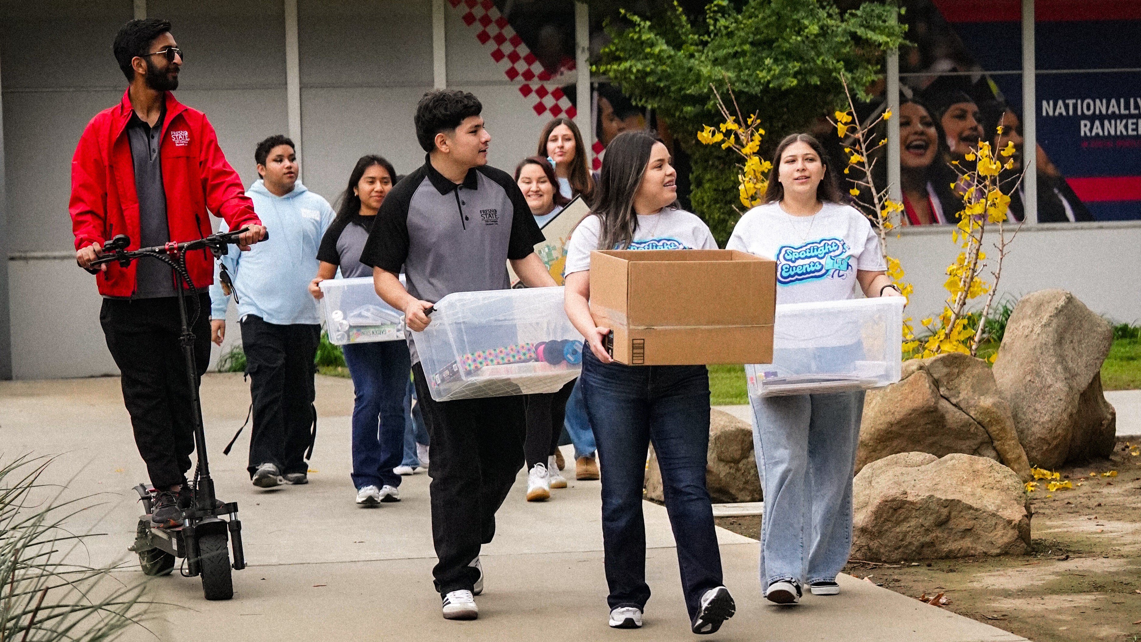 Group of students carrying supplies for event