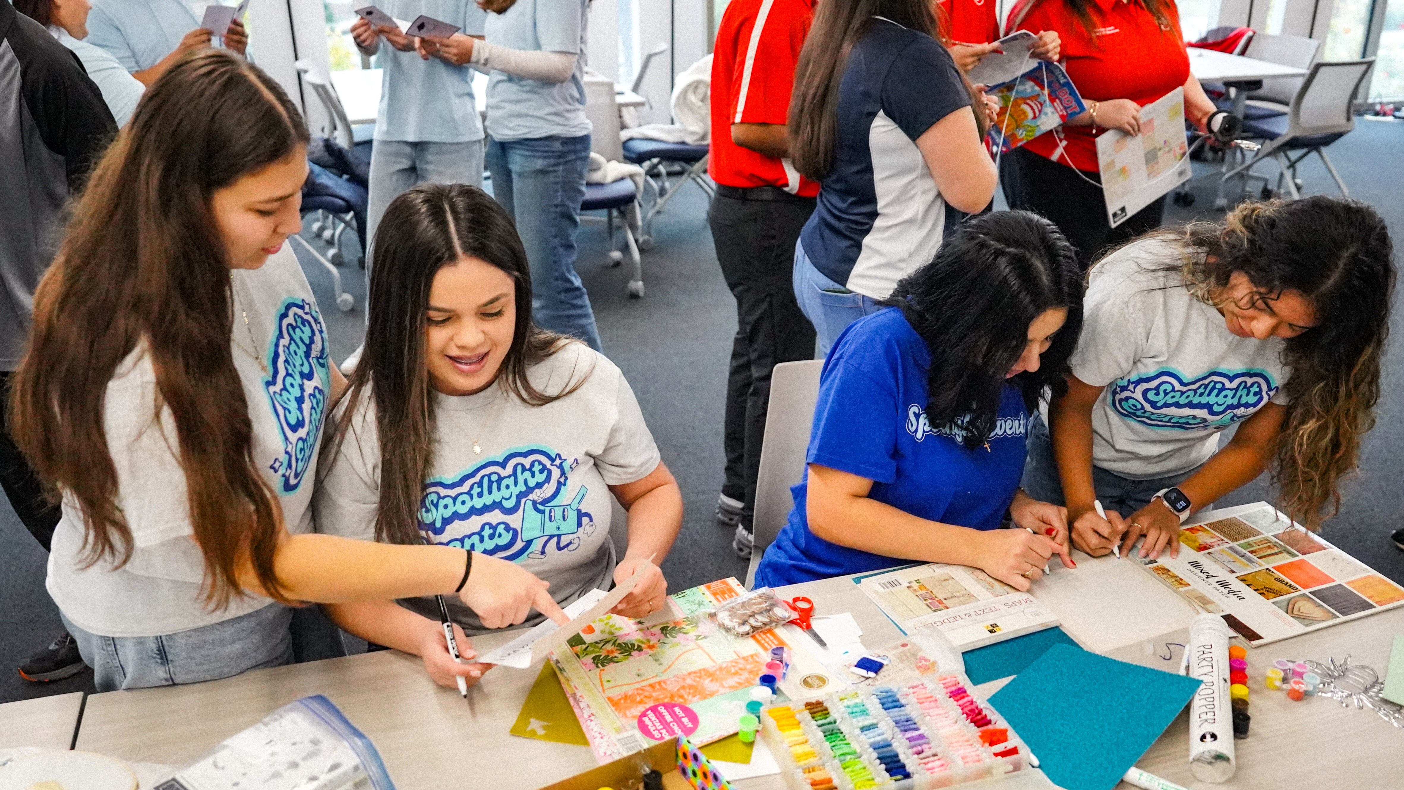 Four members of Spotlight planning for an event and vision-boarding it