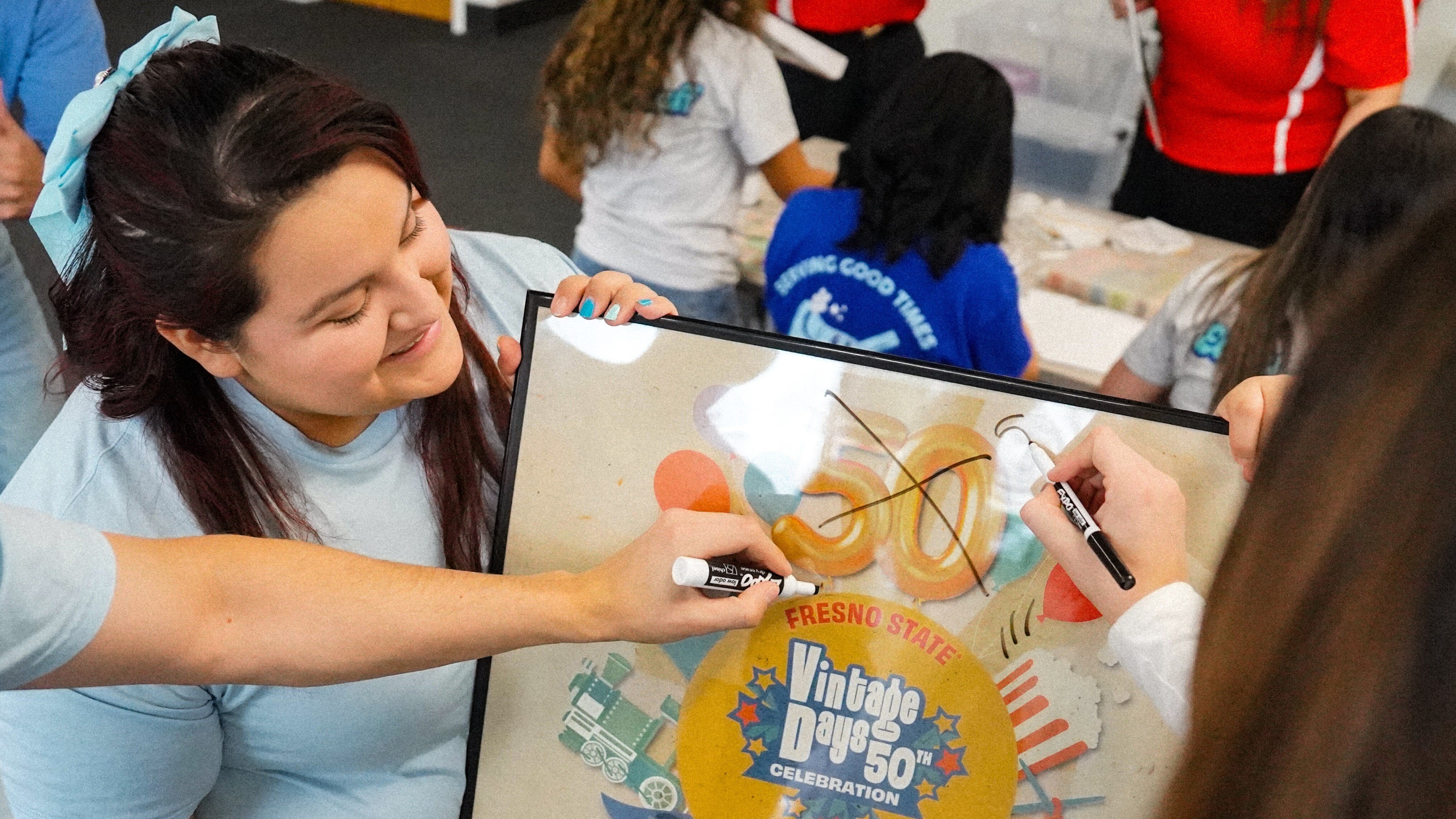 Members of Vintage Days mocking up a new poster