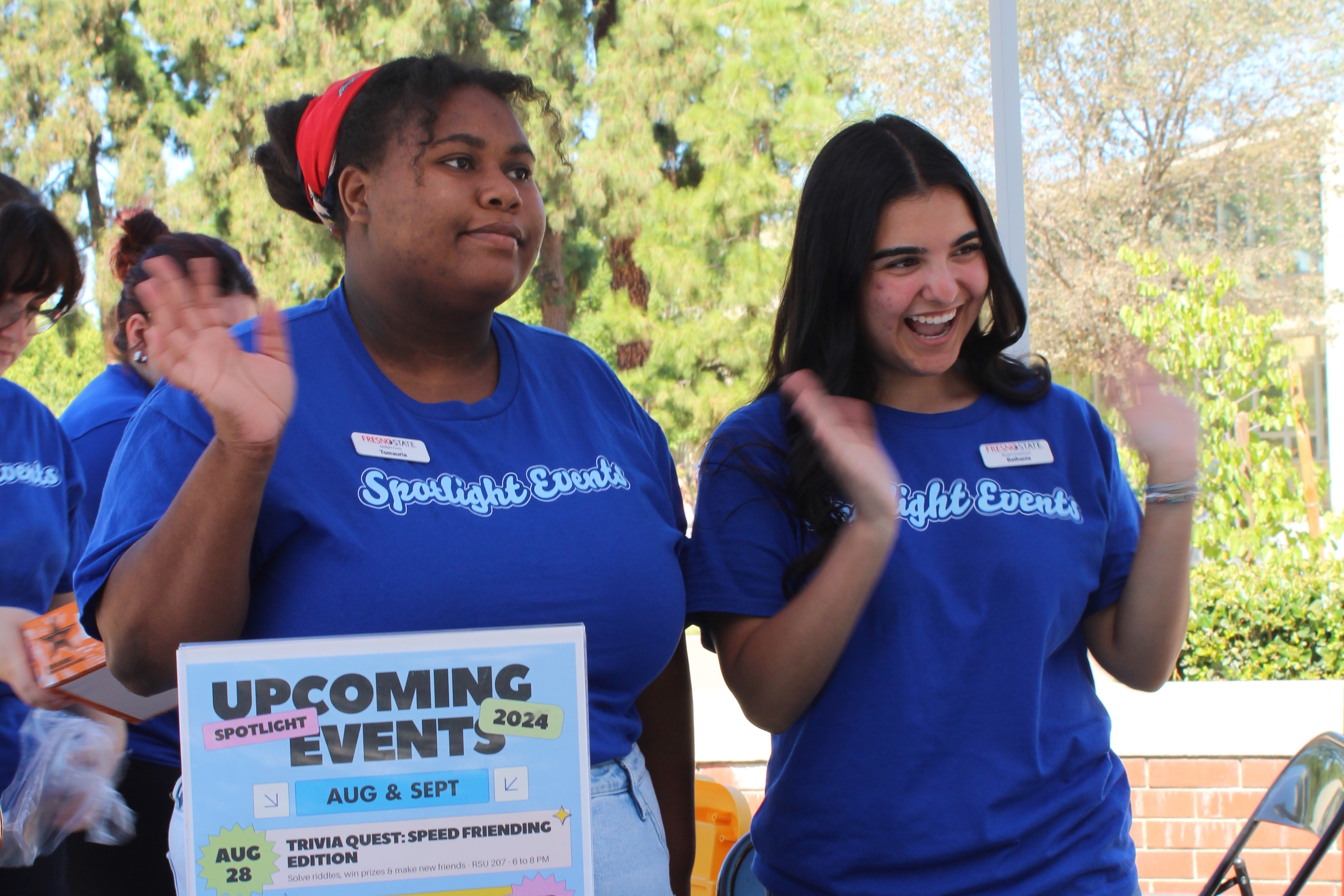 Two members of the Spotlight committee table and greet students