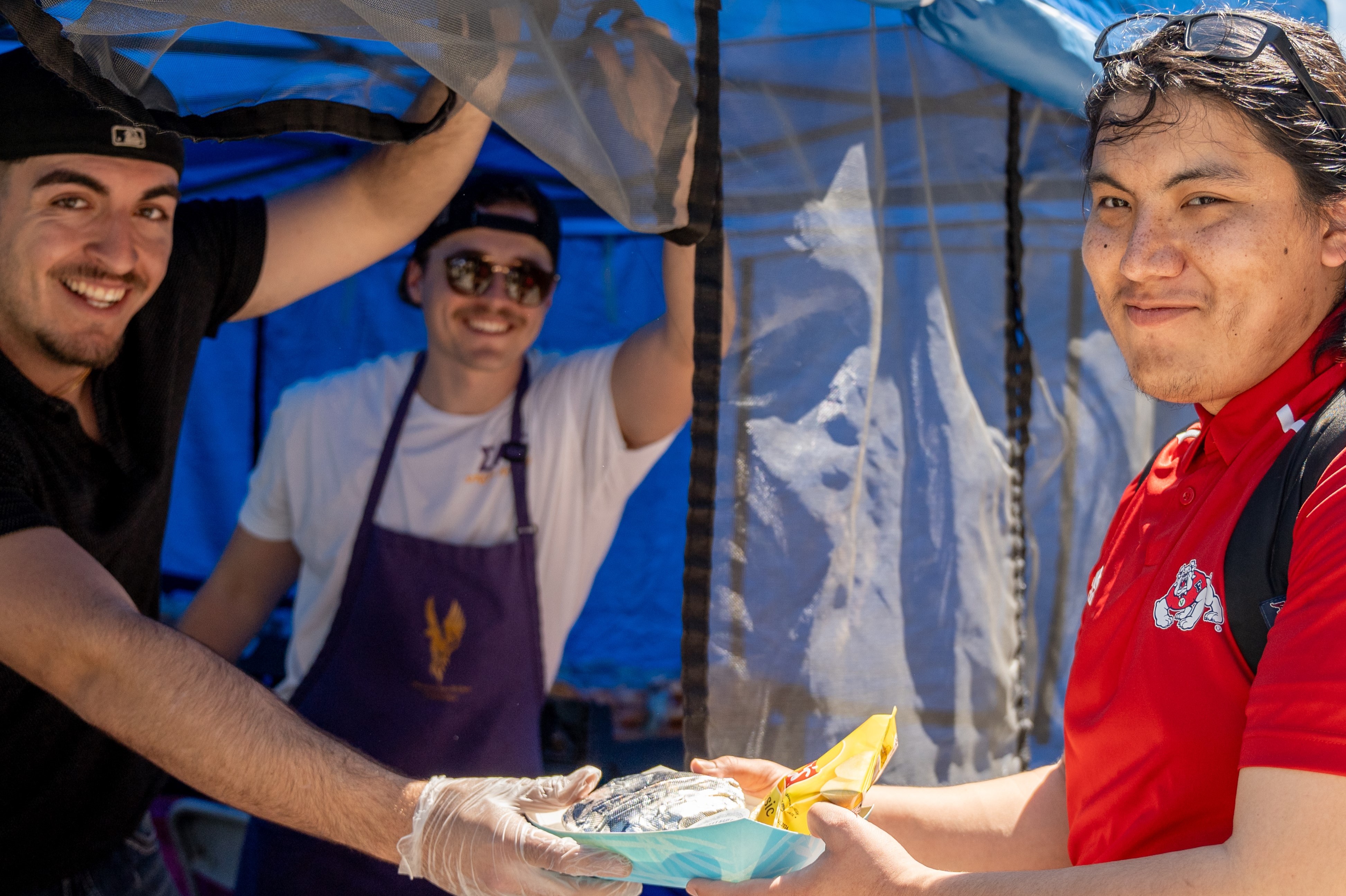 Student club food booth serves with a smile