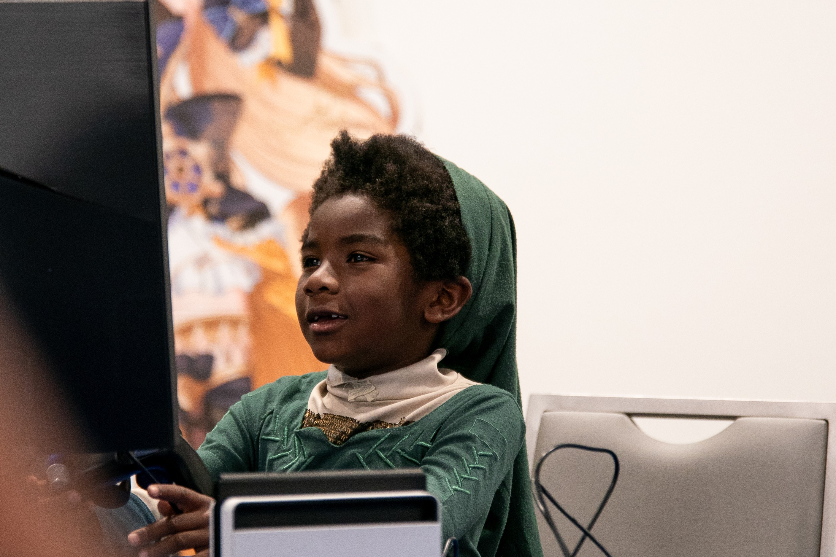 Young kid cosplaying Link playing on a computer