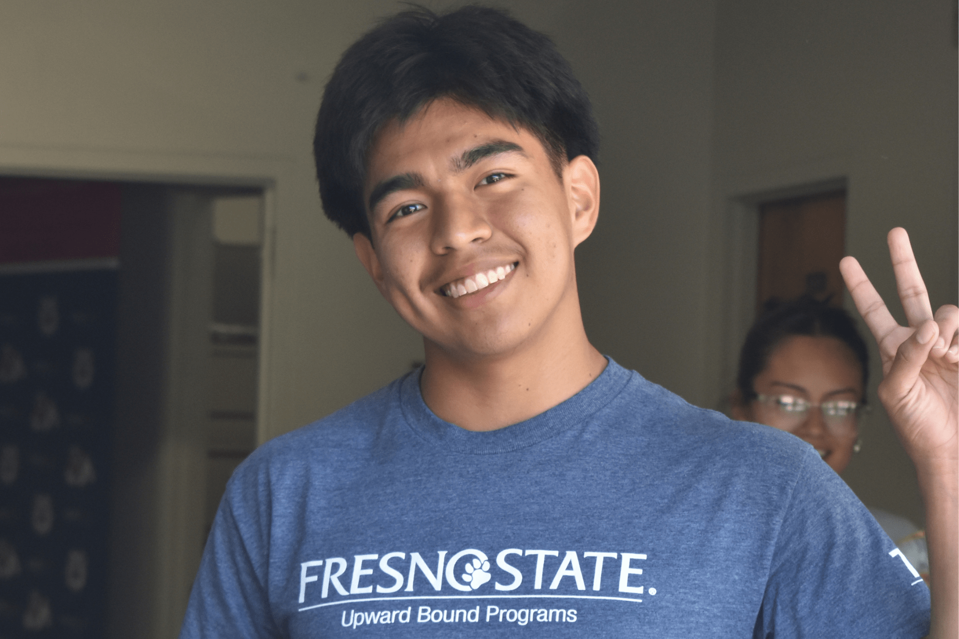 picture of upward bound student in front of upward bound office