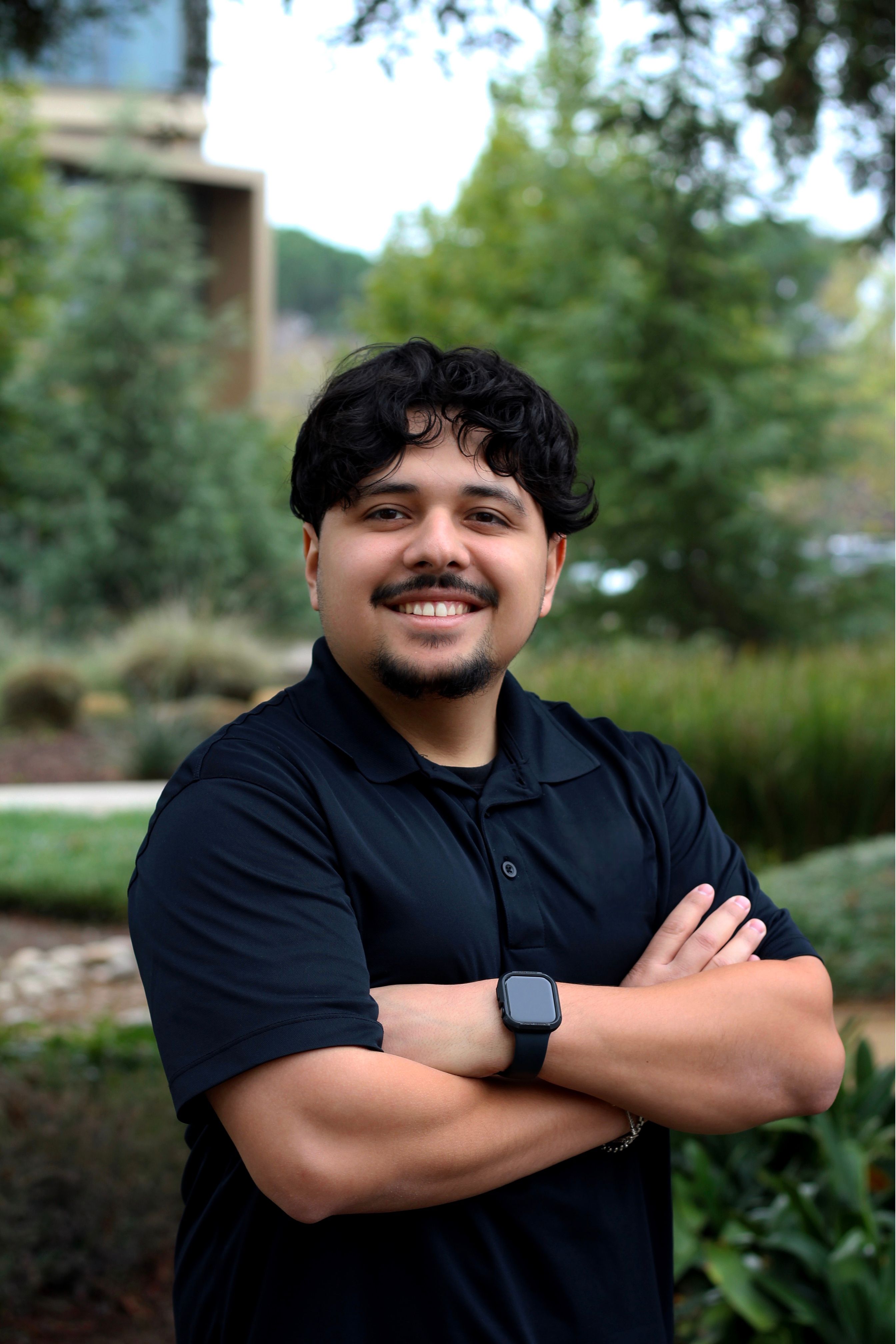 picture of Angel Ernesto Barraza, Administrative Assitant of Upward Bound Programs, standing outside of RSU garden
