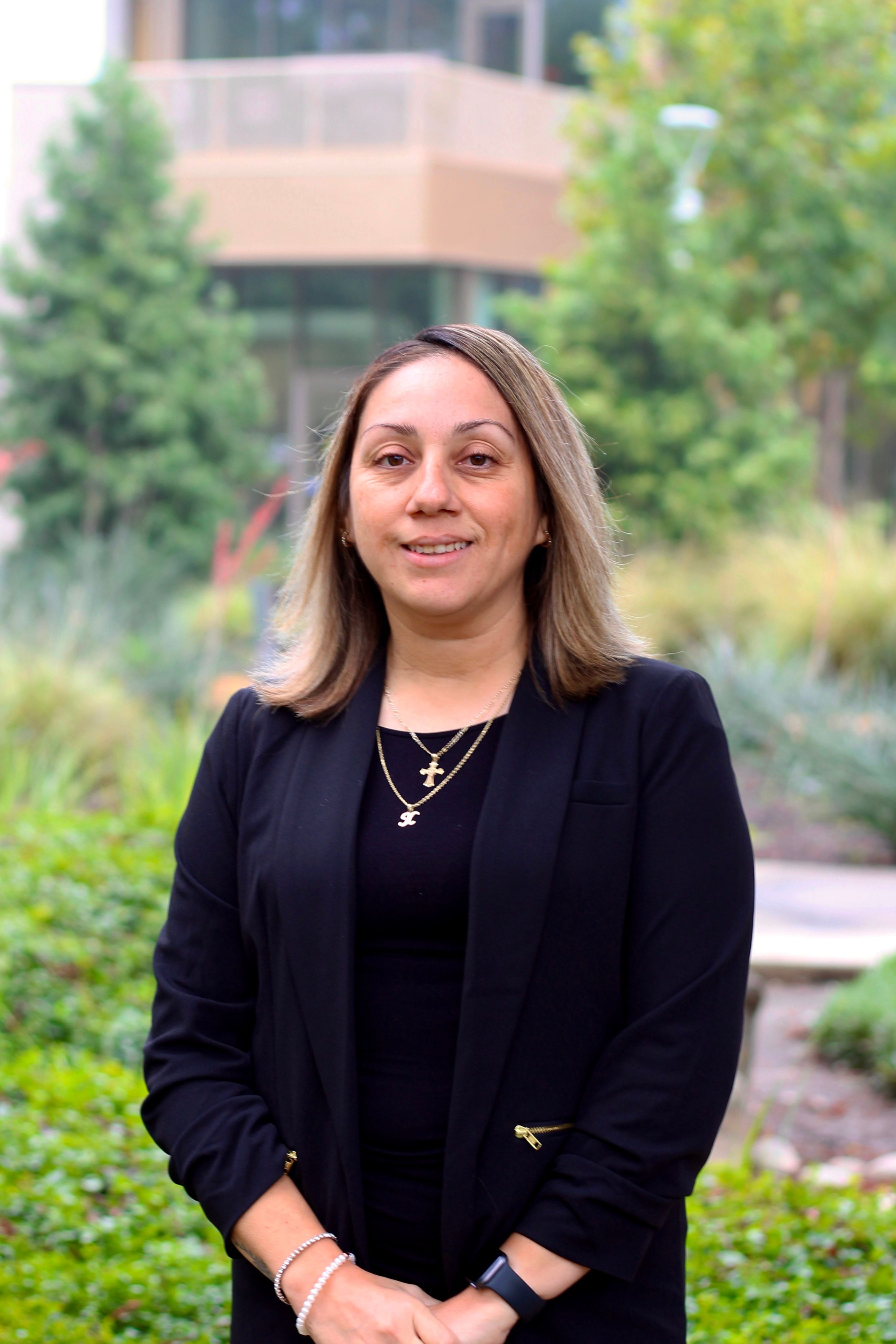 picture of Anarely Bautista-Ayers, Classic Counselor of Upward Bound Programs, standing outside of RSU garden