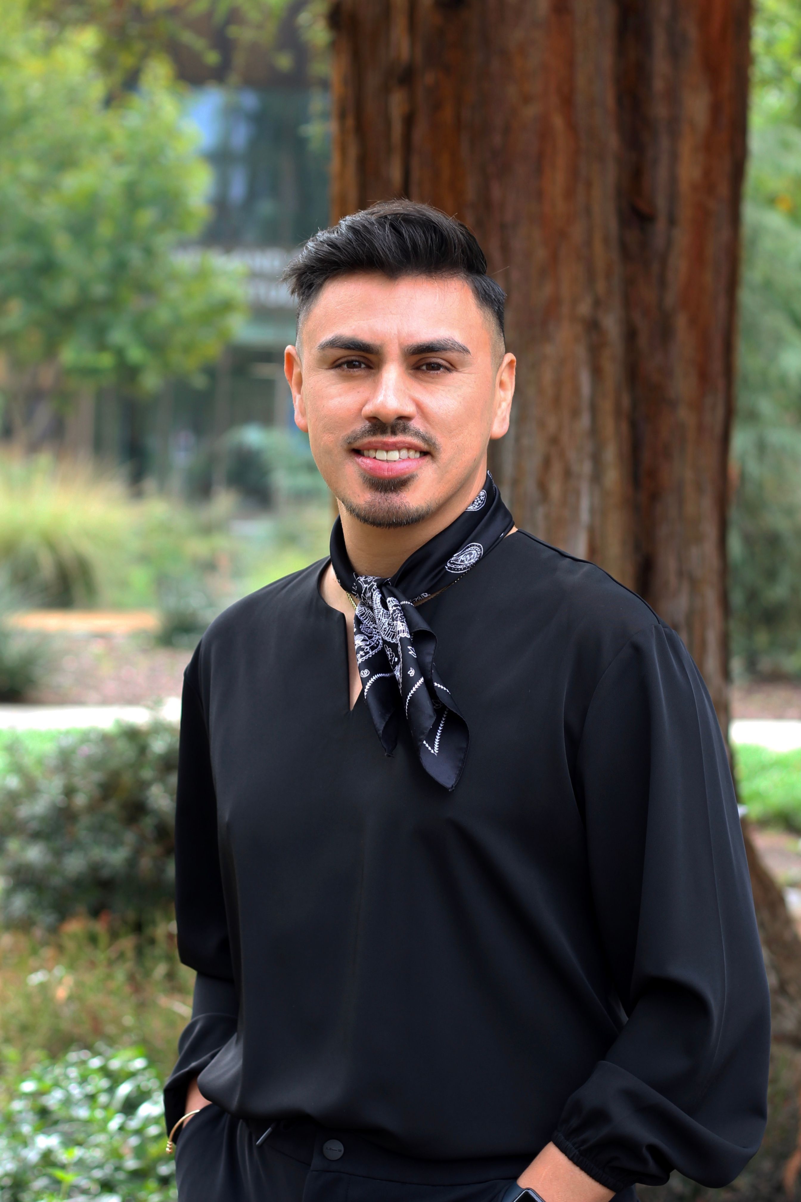 picture of Dr. Estevan Parra-Guerrero, Director of Upward Bound Programs, standing outside of RSU garden