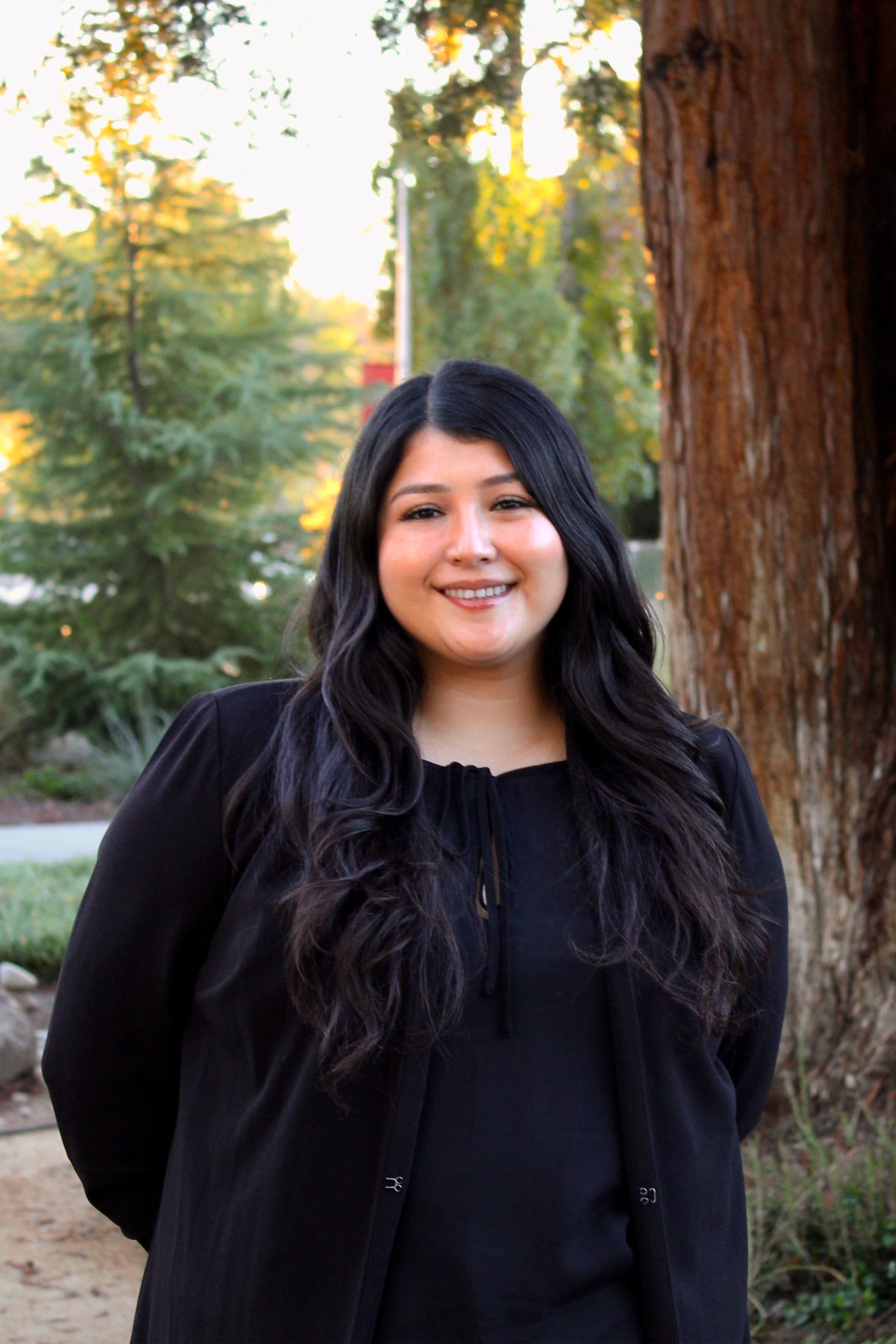 picture of Jasmin Ledesma-Villa, Next Gen Counselor of Upward Bound Programs, standing outside of RSU garden