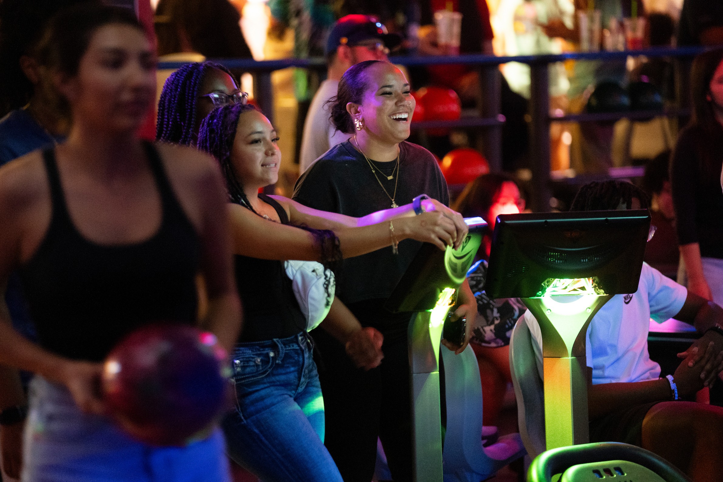 People watching their friends bowling