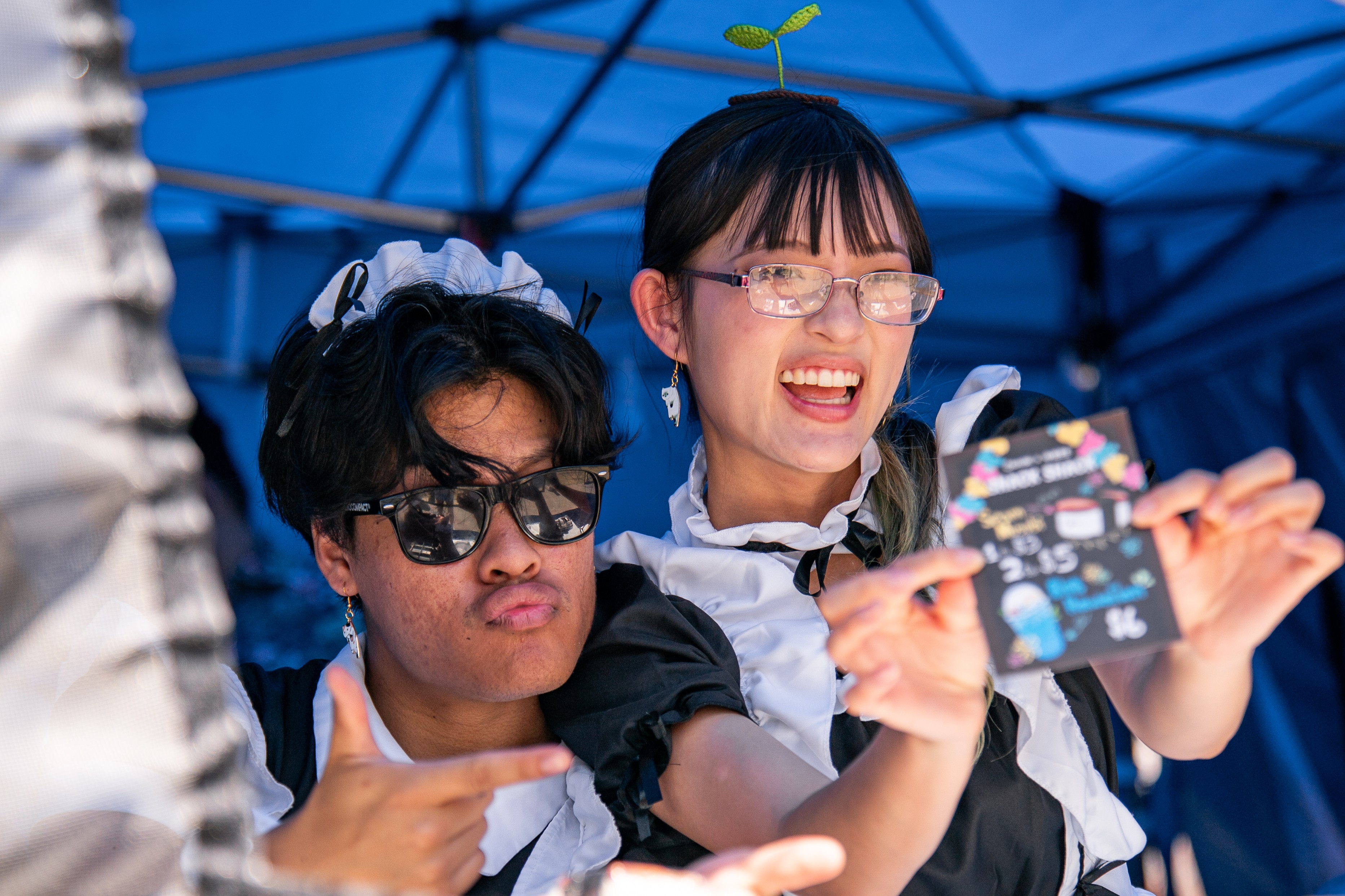 Two members of a student org posing and selling spam musabi